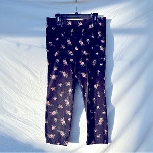 Black floral pull on stretchy pants. Ankle cropped.